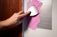 A handyman applying dry wall